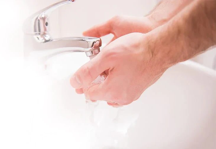 Washing and rinsing hands in the bathroom sink