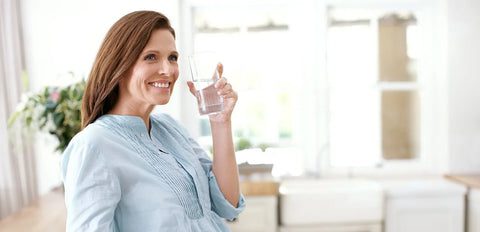 woman drinking glass of water with a